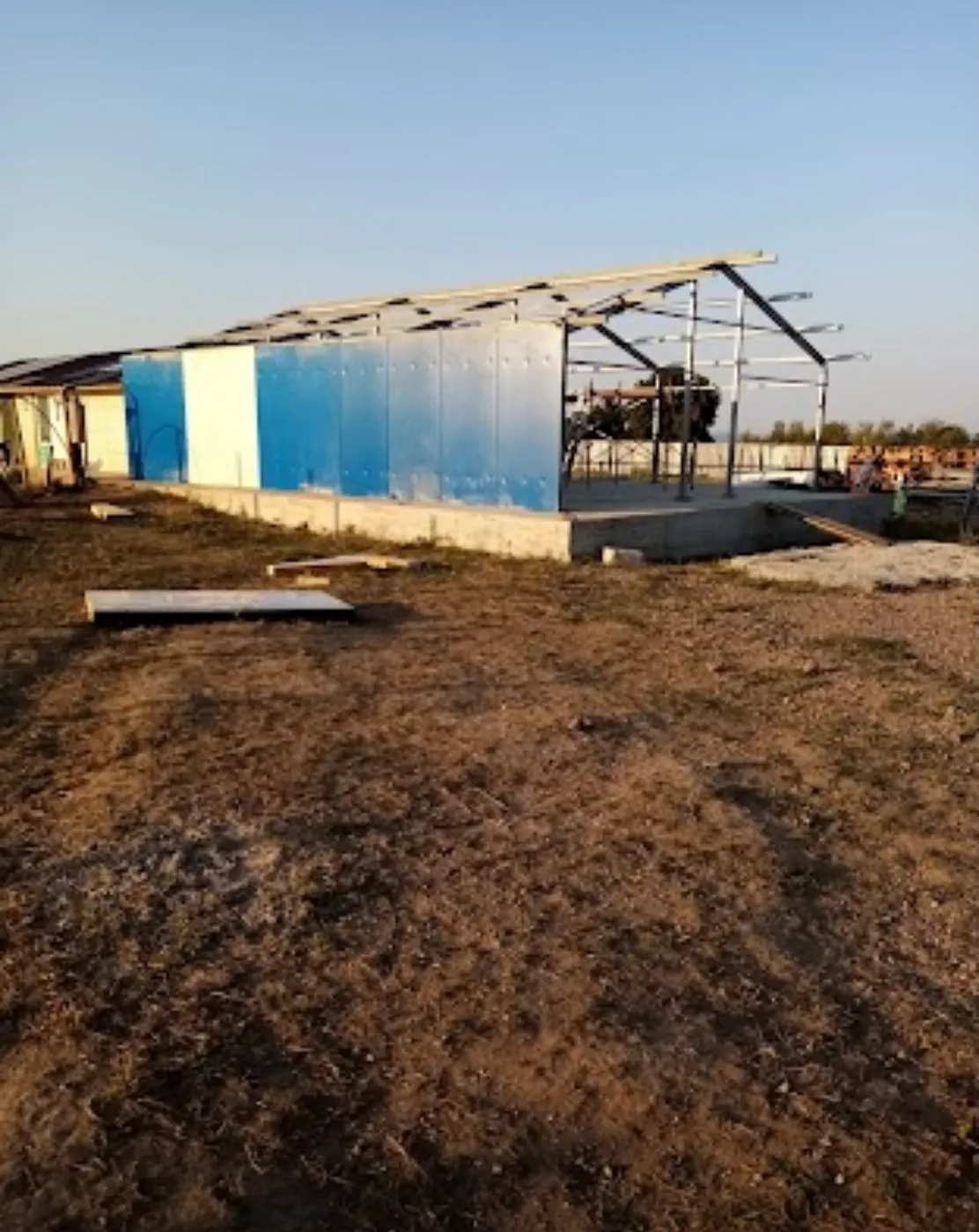 The steel frame and blue wall panels up close.